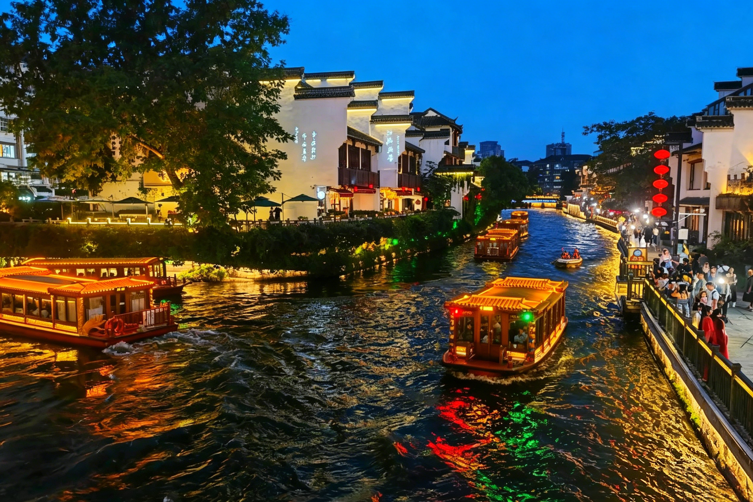 The Qinhuai River at night — painted boats, red lanterns, and Ming Dynasty architecture reflected in the water