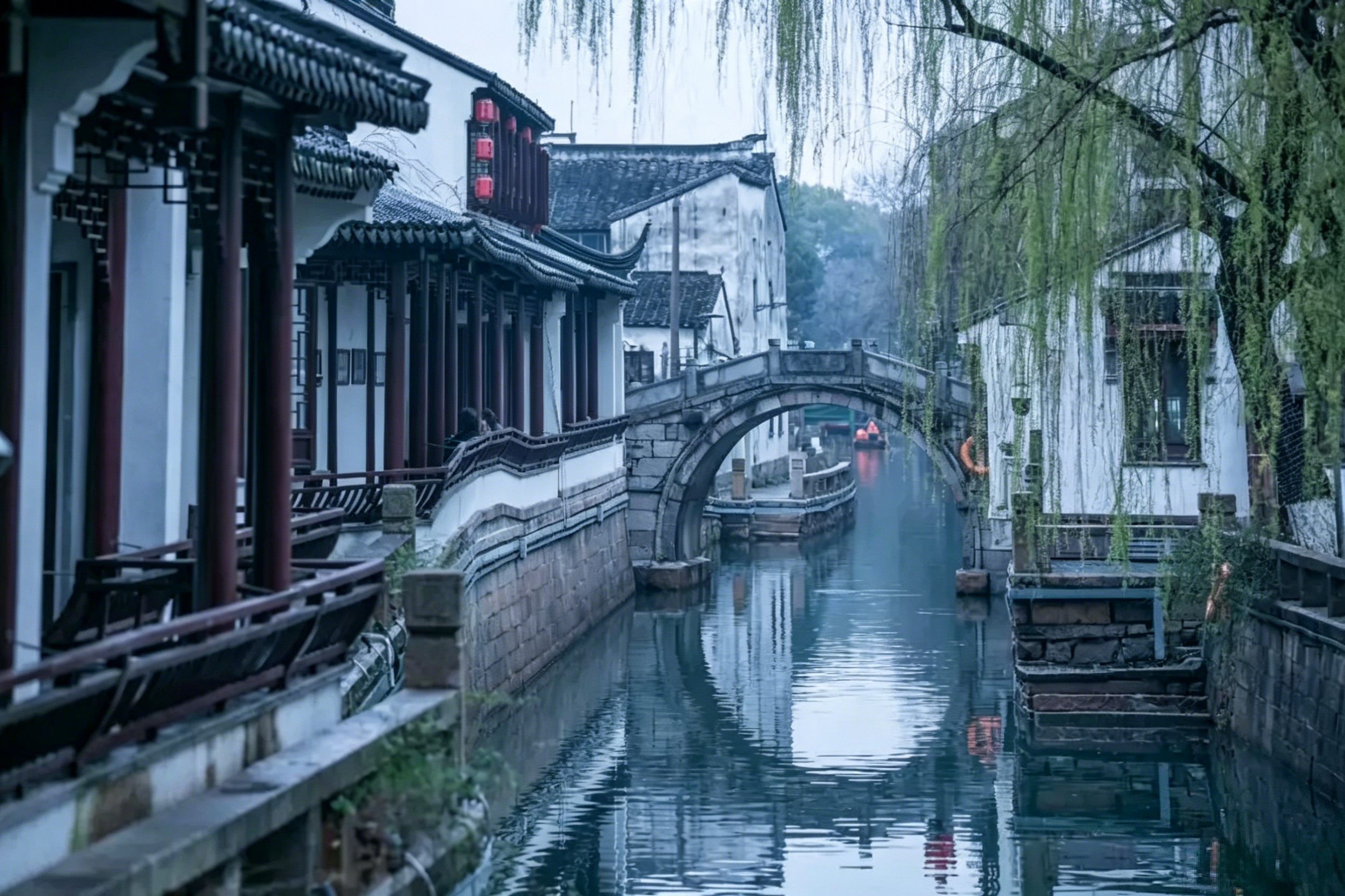 Pingjiang Road at dusk — whitewashed houses, willow-fringed canals, and red lanterns reflecting in still water
